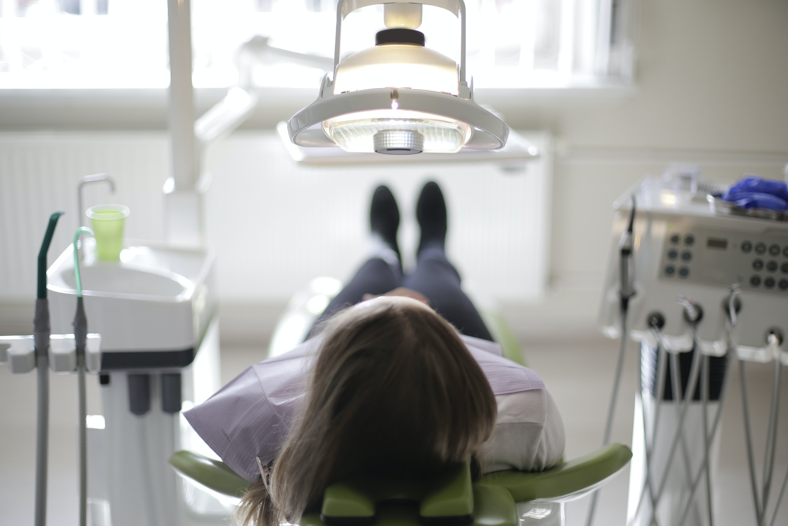 Woman in White Shirt Sitting on Green Chair